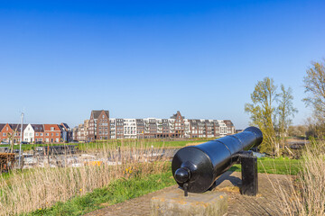 Historic cannon on top of the dike in Grave, Netherlands