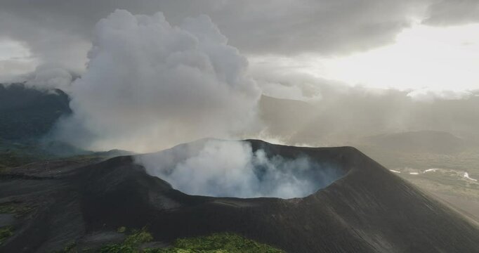 Fiji, Tana Island: Yasur Volcano erupting smoke and ash plumes into the atmosphere, creating a dramatic scene above Vanuatu. Wild nature travel landscape. Drone flight footage, aerial view