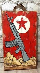 Fototapeta premium Stylized Assault Rifle on Distressed Wood Panel with Red Star Emblem