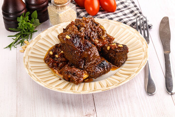 Prepared tasty beef ribs with sauce