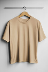 Beige T-Shirt Hanging on Wooden Hanger