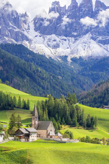 Dolomites, Italy. Aerial wide panoramic view of St. Magdalena or Santa Maddalena church, Geisler Odle mountains and green alpine meadows
