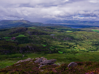 Views from coomloughra horseshoe hiking trail over green hills and fields in county kerry, Ireland.