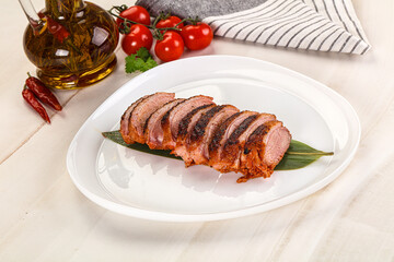 Sliced duck breast baked with cherry