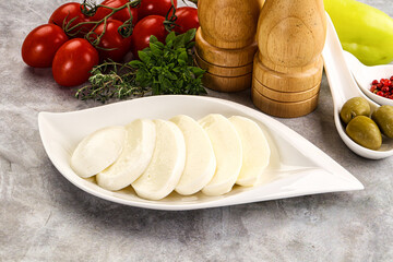 Organic mozzarella cheese slices in the plate