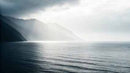 Beautiful seascape with fog and mountains in the background.