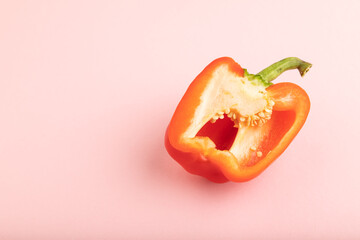 Red Cutted pepper on pink  pastel, slice on blue pastel, Side view, copy space.