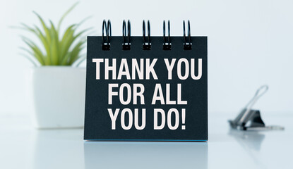 A black notebook with the words Thank you For All You Do written on it