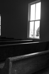 Black and white image of the interior of the historic Methodist church in Cades Cove, with three...