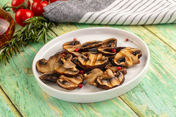 Tasty hot grilled champignon mushrooms