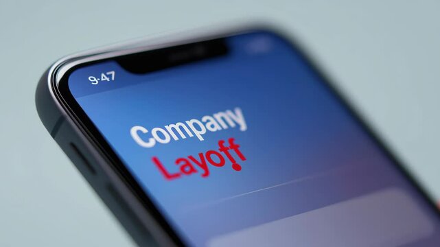 Layoff employee and unemployment concept, Smartphone screen displaying a notification about layoffs.