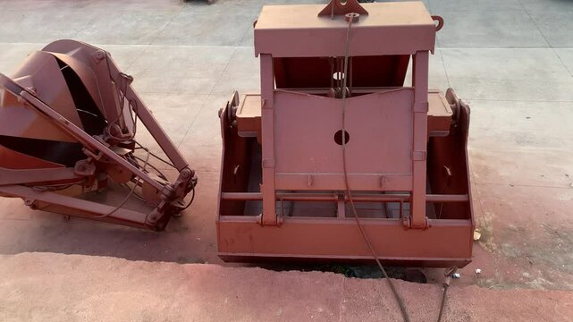A vessel-mounted or ship-mounted heavy-duty clamshell grab bucket used for dredging or material loading.
