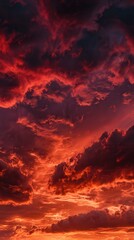 Fototapeta premium Bright red sunset. Dramatic evening sky with clouds. Fiery skies with space for design. Magic fantasy sky. War, battle, terror, world apocalypse, horror concept.