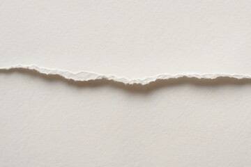 A solitary tear in white paper, symbolizing a moment of disruption or change