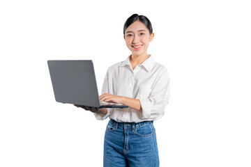 Asian woman in a casual outfit smiles at the camera while holding and typing on a laptop,...