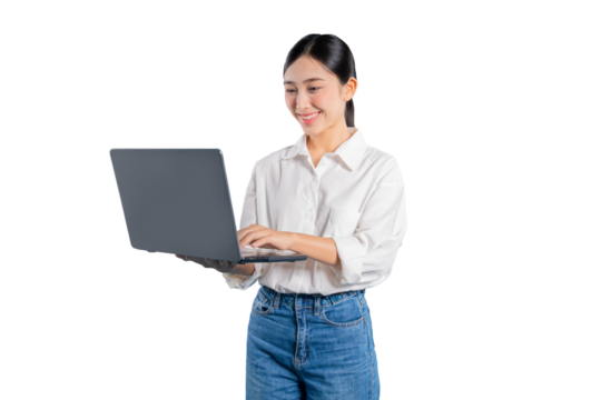 Asian woman smiles pleasantly as she holds a laptop and works, looking focused and content while typing or reading from the screen against a solid png background.