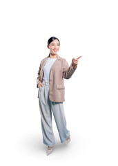 Asian businesswoman with one hand in her pocket points her finger to the side, smiling as she directs attention to a product or information in the copy space.