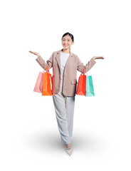 A happy young Asian woman walks forward, presenting her shopping bags with open palms and a welcoming smile, as if showing off her great finds against a solid png background.
