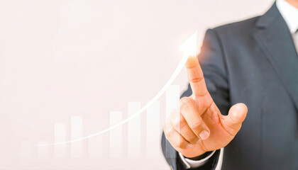Photography advertising shot of close up businessman touching an upward arrow on a virtual graph with empty background.
