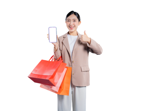 young Asian woman holding shopping bags looks at her smartphone with a bright smile, possibly communicating with friends about her purchases or browsing for more deals online, against a png
