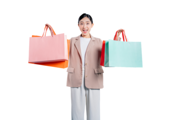 young Asian woman with a joyful, open-mouthed expression holds her colorful shopping bags out to the sides, celebrating a fantastic shopping haul against a png background.
