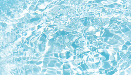 Blue water with ripples on the surface. Defocus blurred transparent blue colored clear calm water surface texture with splashes and bubbles. Water waves with shining pattern texture background.