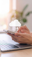 Photography of a person using the phone and labtop with cloud icon on the screen.