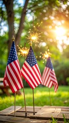 Small US flags with sparklers on a wooden pallet outdoors