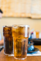Refreshing iced tea and soft drink on wood tabe at restaurant