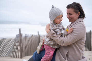 Portrait of mother and little daughter on the beach
