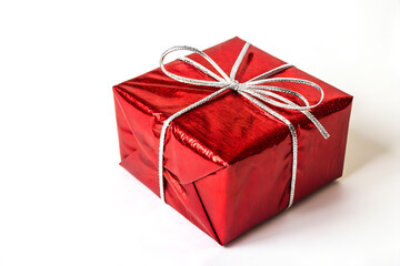 Shiny Red Gift Box with Silver Ribbon on White Background
