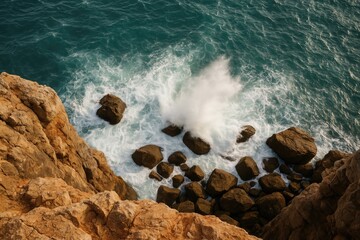 Fototapeta premium View from a cliff overlooking water crashing on rocks