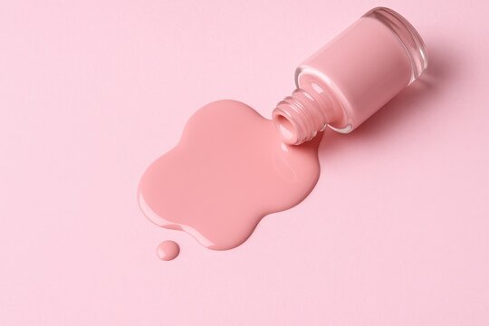 Soft pink pastel background featuring spilled nail polish, ideal for a blog cover image.