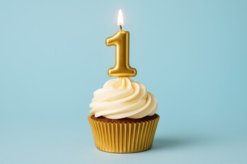 Gold candle decoration on a cupcake with a pastel blue backdrop for celebration