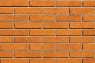 Obraz premium Textured orange brick wall for wallpaper design