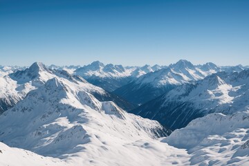 Naklejka premium Vast landscape of snow-draped peaks under a clear blue sky