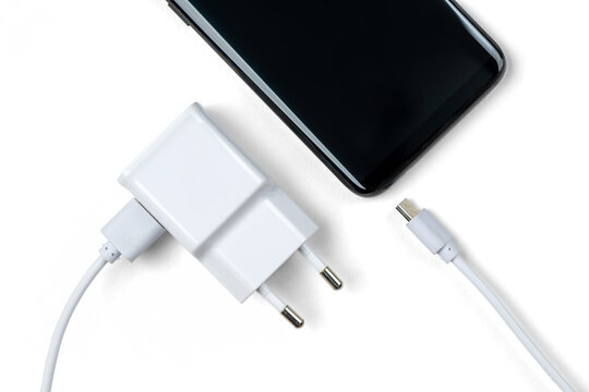 Minimal mobile phone charger with USB cable and smartphone. Transparent background PNG. Modern digital device concept, clean tech gear for charging portable electronics.