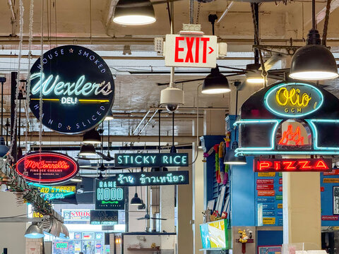 Los Angeles, California, USA - April 18, 2024: Colorful neon signs representing various food vendors at Grand Central Market, featuring diverse culinary offerings under one roof