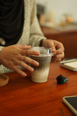 A Cup of milkshake topping white black sesame on the wood table