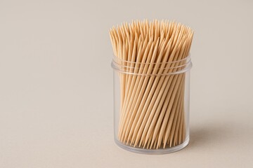 Plastic bottle containing toothpicks isolated on white background