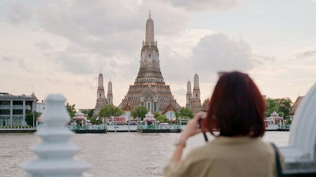 Solo journey of happy southeast asian woman exploring Bangkok. female traveler and backpacker enjoys memorable trip through Thailands vibrant culture and temples