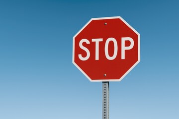 Stop traffic sign under clear blue sky