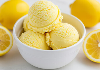 Close-up of a white bowl filled with three scoops of lemon ice cream, garnished with a mango slices