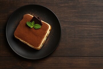 Delicious Tiramisu displayed on rustic wooden surface from a top-down perspective with area for customization
