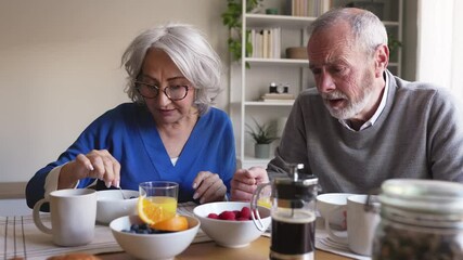 Senior couple enjoying breakfast and coffee together - Powered by Adobe