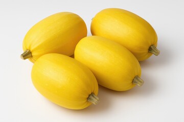 Mature spaghetti squash displayed against a plain white backdrop