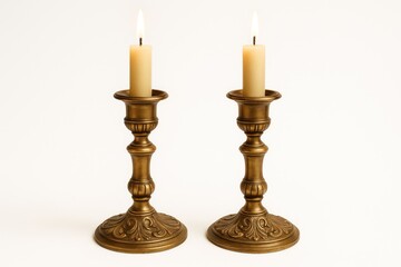 Fototapeta premium Vintage-style candle holders made of brass on a white background