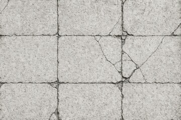 Rough textured concrete floor with a shattered, grungy square pattern