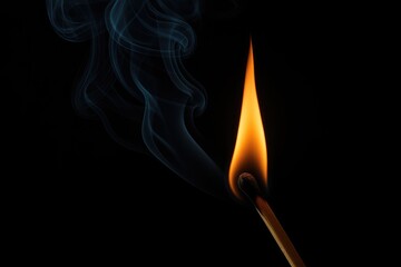 Dark background with a silhouette of a lit matchstick