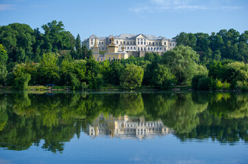 Obraz premium Scenic View of a Historic Vyshnivets Palace and church in front of it Reflected in the Calm Waters, Ukraine
